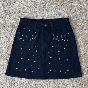 Black denim skirt with metal and pearl buttons. Size SMALL.